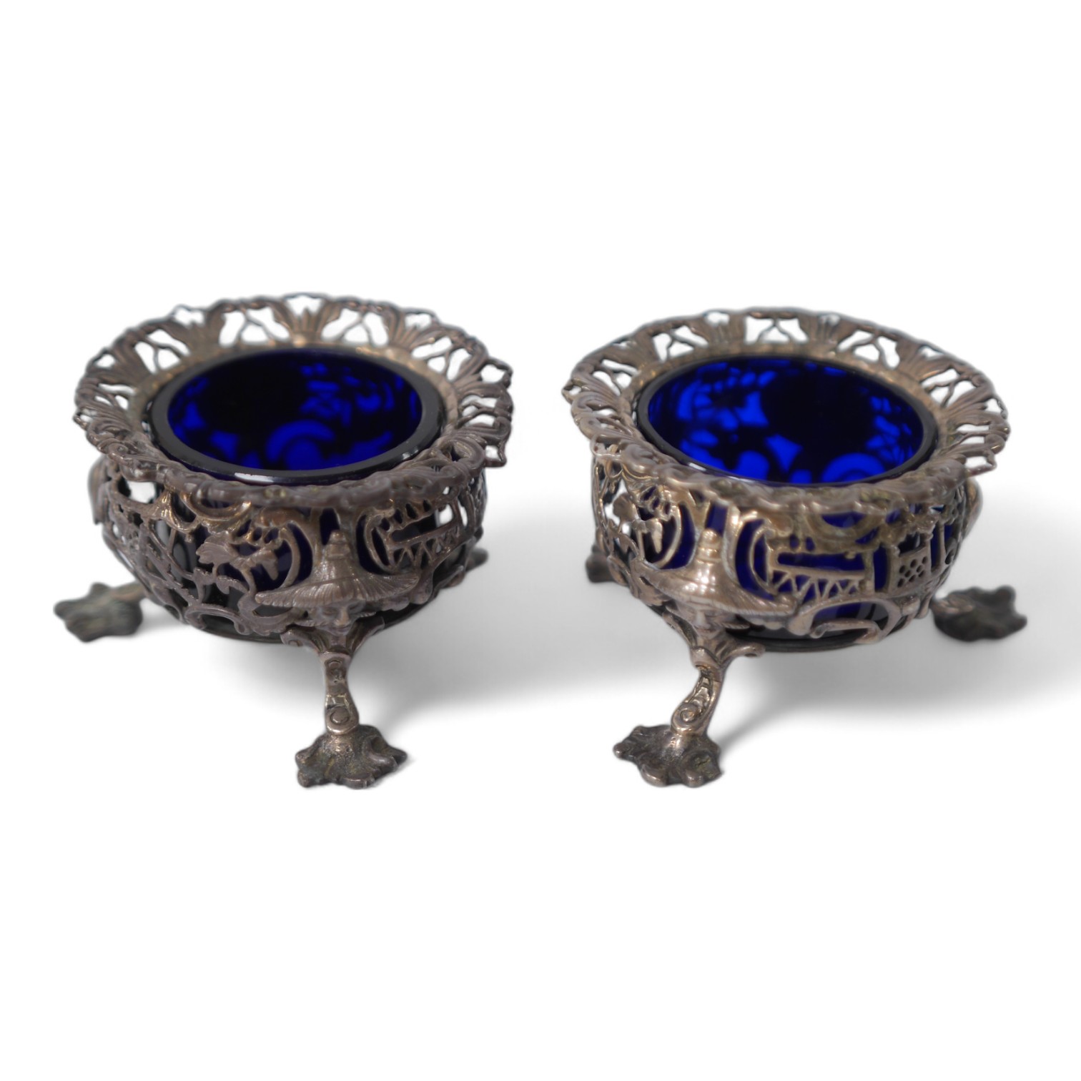 A pair of early Victorian pierced silver circular salts, with mask knees and scroll pad feet, John Wellby, London, 1841, diameter 77mm. Condition - fair